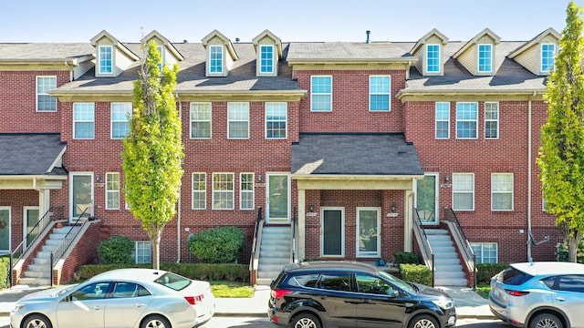 townhome / multi-family property featuring brick siding and a residential view