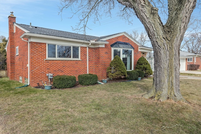 view of property exterior with a yard, brick siding, a chimney, and roof with shingles