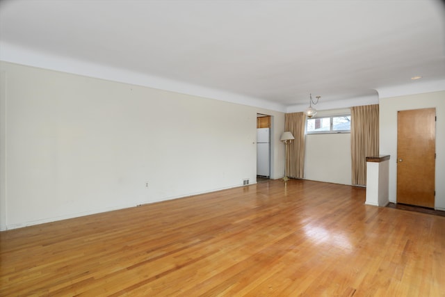 unfurnished room featuring light wood-style floors