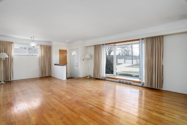 unfurnished living room featuring light wood finished floors and visible vents