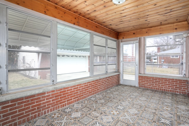 unfurnished sunroom with wood ceiling