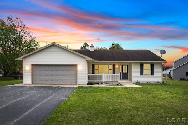 ranch-style home featuring a garage, a chimney, aphalt driveway, covered porch, and a front yard