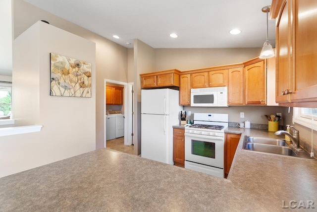 kitchen with lofted ceiling, recessed lighting, a sink, white appliances, and independent washer and dryer