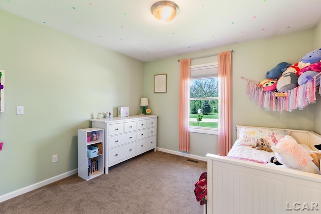 carpeted bedroom featuring baseboards and visible vents