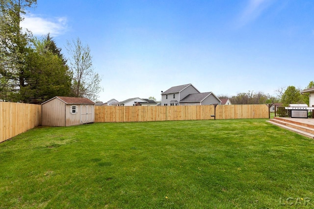 view of yard with a fenced backyard, an outdoor structure, and a storage shed