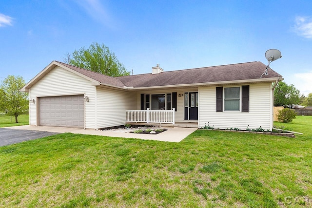 ranch-style home with a garage, a chimney, aphalt driveway, a porch, and a front yard