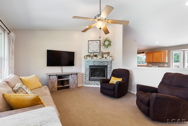 living room with light carpet, baseboards, ceiling fan, a fireplace, and recessed lighting