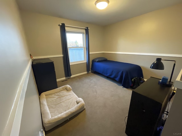 bedroom with carpet flooring, visible vents, and baseboards