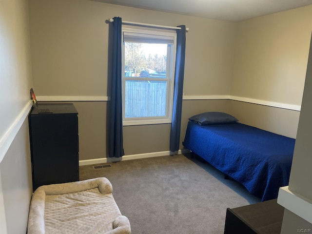 carpeted bedroom with visible vents and baseboards