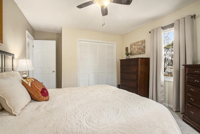 bedroom featuring carpet floors, a closet, and a ceiling fan