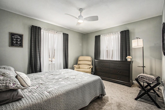 bedroom featuring a ceiling fan and light colored carpet