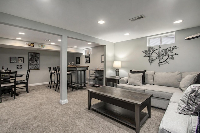 living area featuring a dry bar, light carpet, baseboards, visible vents, and recessed lighting