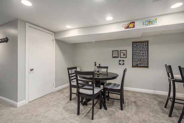 dining area featuring recessed lighting, light carpet, and baseboards