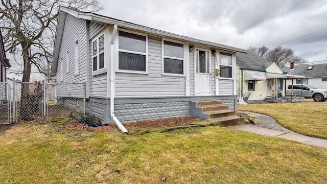 view of front of property with fence and a front lawn