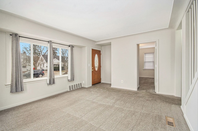 carpeted empty room with baseboards and visible vents