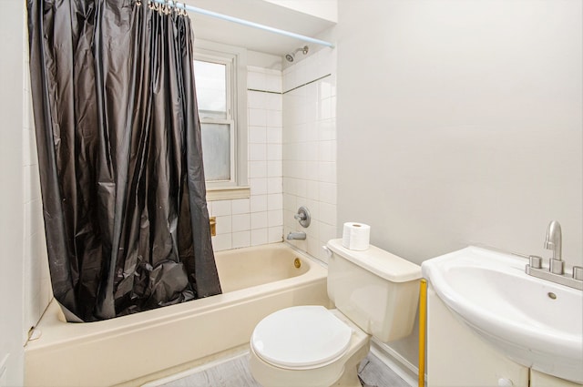 bathroom with a sink, toilet, and shower / tub combo with curtain