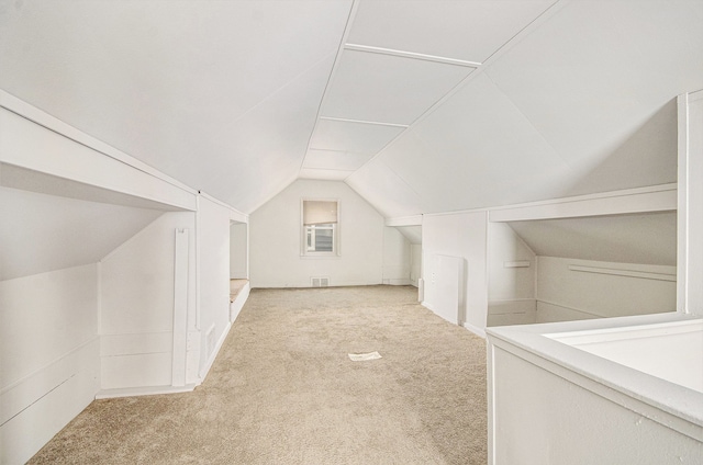 bonus room featuring vaulted ceiling, carpet, and visible vents