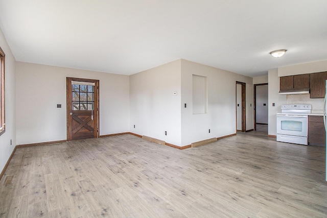 unfurnished living room featuring light wood-type flooring and baseboards