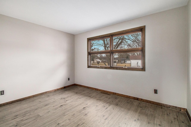 empty room with wood finished floors and baseboards