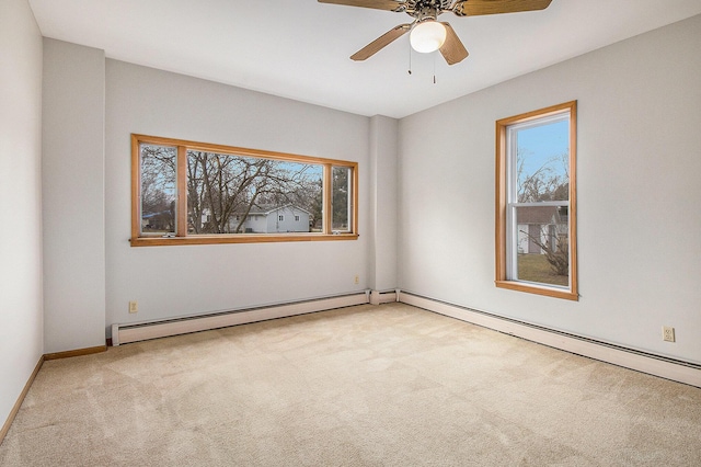unfurnished room with carpet, a baseboard radiator, and ceiling fan