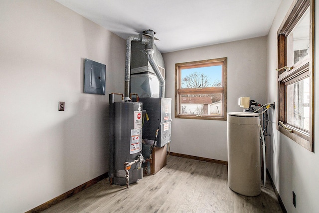 utility room featuring gas water heater and electric panel
