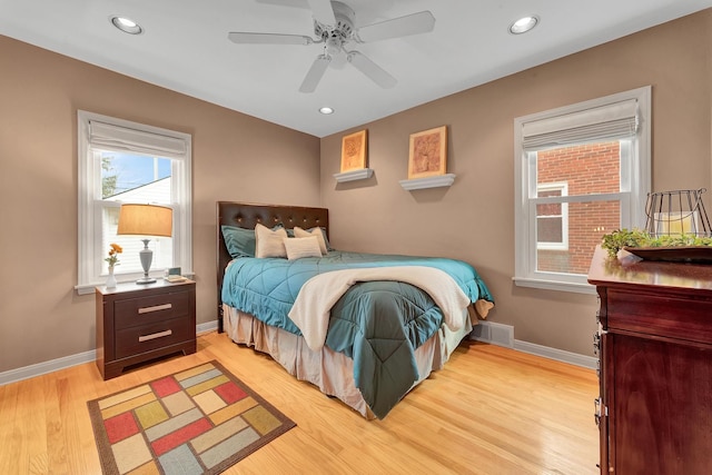 bedroom featuring light wood-type flooring, visible vents, baseboards, and recessed lighting