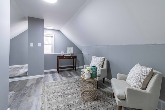 sitting room with lofted ceiling, wood finished floors, and baseboards