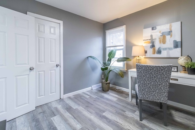 home office featuring baseboards and wood finished floors