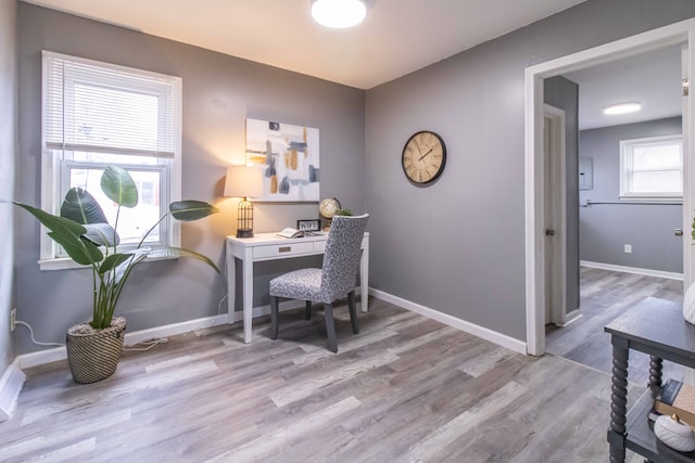 office area with baseboards and wood finished floors