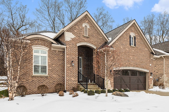 view of front of property featuring a garage and brick siding