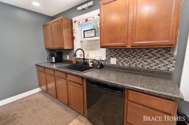 kitchen with dark countertops, dishwasher, backsplash, and a sink