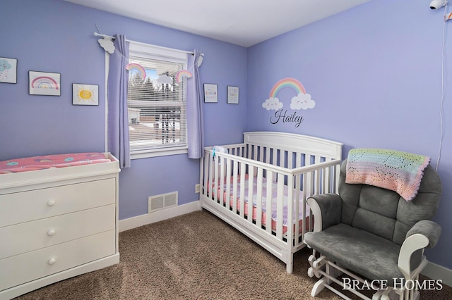 carpeted bedroom featuring visible vents, a crib, and baseboards