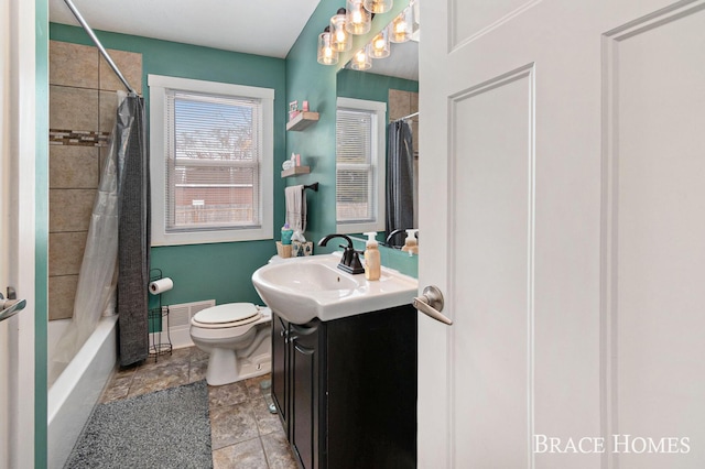 bathroom with shower / bathtub combination with curtain, vanity, and toilet