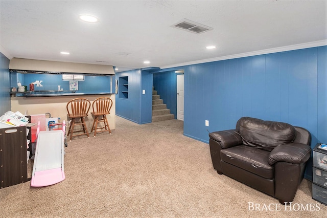 interior space with a dry bar, recessed lighting, visible vents, ornamental molding, and carpet flooring