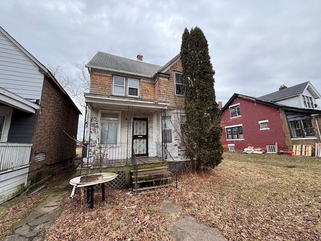 view of front of house with a chimney and a porch