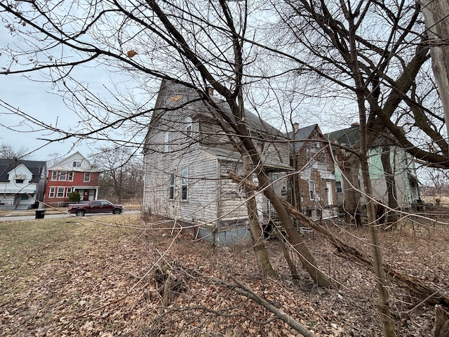 view of home's exterior with a residential view and a chimney