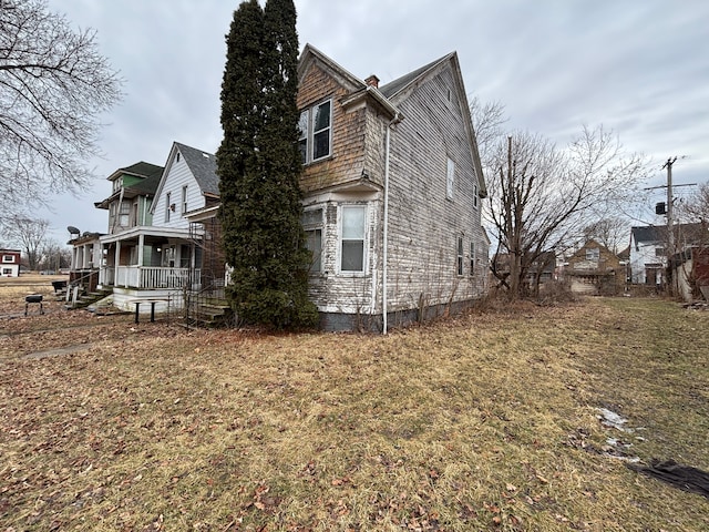 view of property exterior with a porch