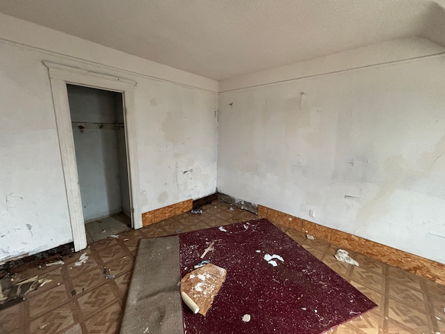 unfurnished bedroom featuring a closet and a textured ceiling