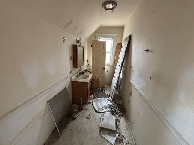 interior space with lofted ceiling and a sink