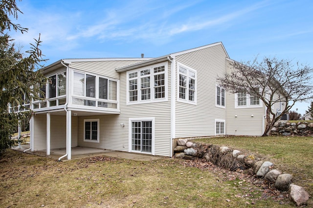 back of property featuring a patio area, a sunroom, and a yard