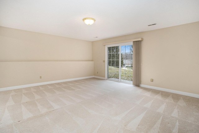 unfurnished room featuring baseboards and light colored carpet