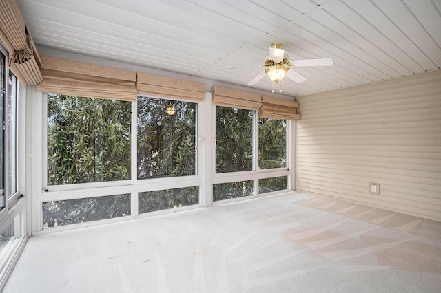 unfurnished sunroom featuring ceiling fan