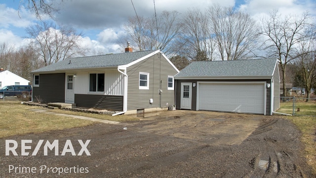 single story home with an outbuilding, a chimney, a shingled roof, fence, and a garage