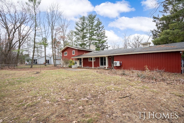 back of property featuring a yard, ac unit, and fence