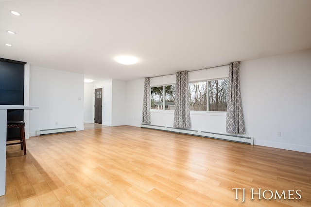 unfurnished living room with recessed lighting, baseboards, light wood-style flooring, and baseboard heating