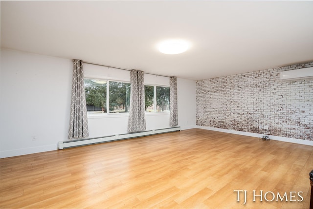 empty room featuring a baseboard heating unit, an AC wall unit, brick wall, and wood finished floors