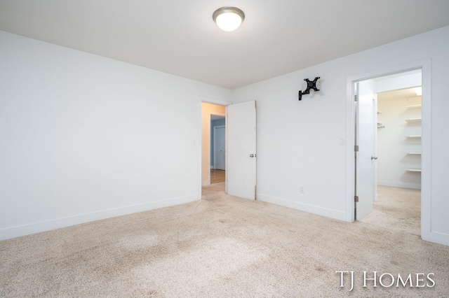 carpeted empty room with baseboards