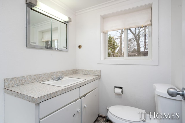 half bath with vanity, toilet, and crown molding