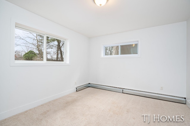 carpeted empty room with a baseboard radiator and baseboards