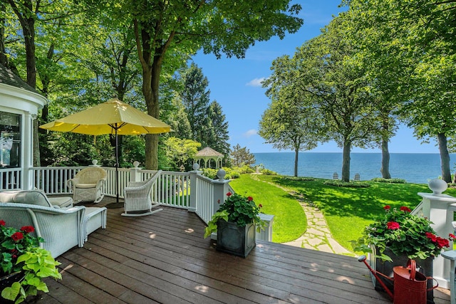 6059 Lakeshore Dr, West Olive, MI 49460 - wooden terrace featuring a water view and a lawn